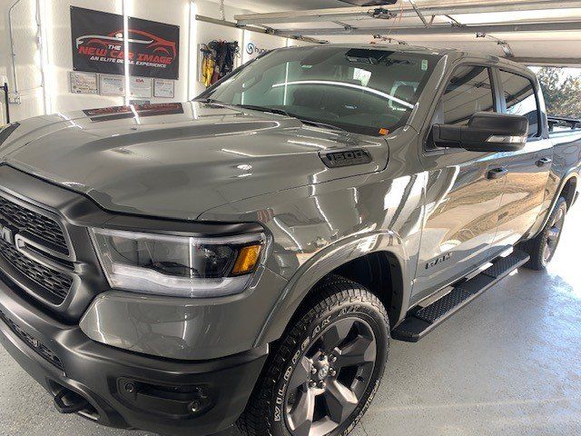 A gray ram truck is parked in a garage.