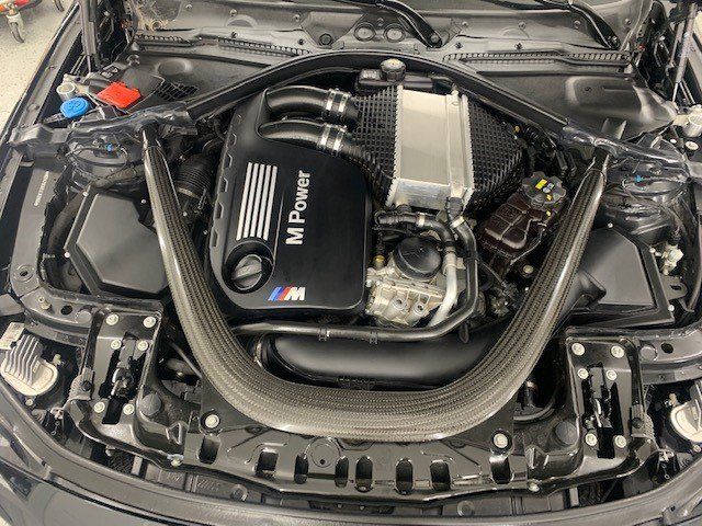 A close up of the engine of a bmw m power car.