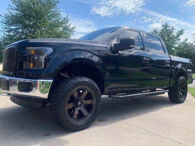 A black pickup truck is parked on the side of the road.