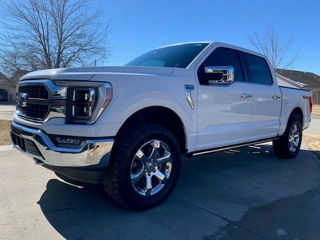 A white truck is parked on the side of the road.