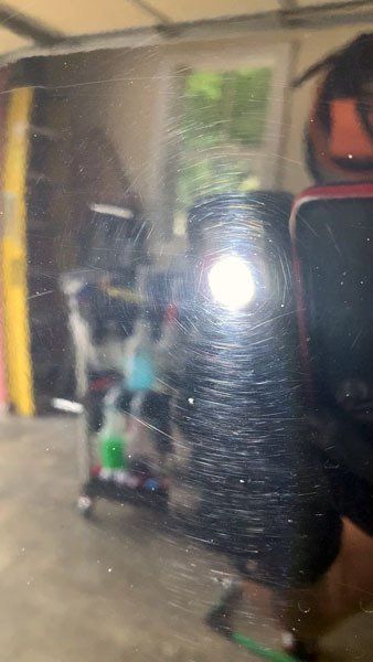 A person is taking a picture of their reflection in a mirror.