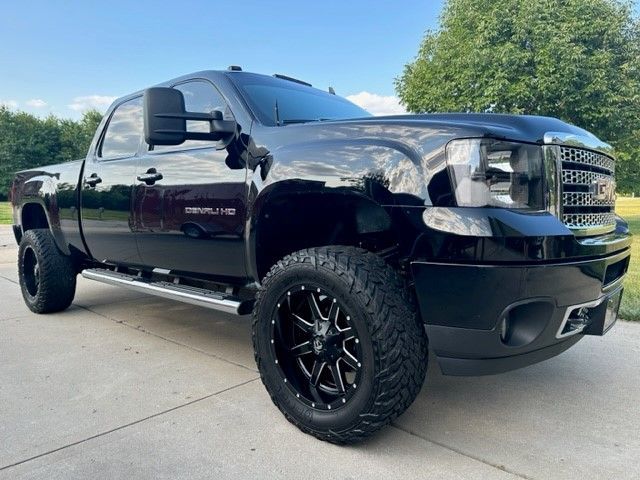 A black truck is parked on the side of the road.
