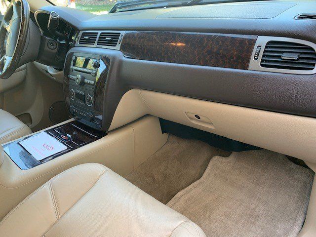 The interior of a car with tan leather seats and a wooden dashboard