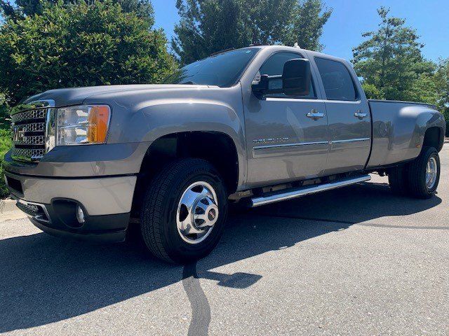 GMC 3500 in front of the new car image