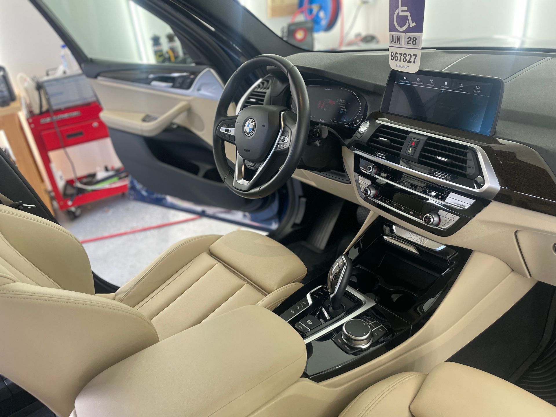 The interior of a bmw x3 is shown in a garage.
