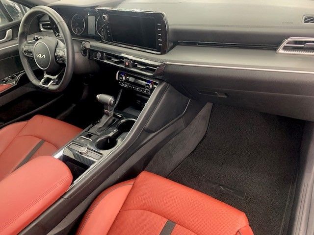 The interior of a car with red seats and a steering wheel