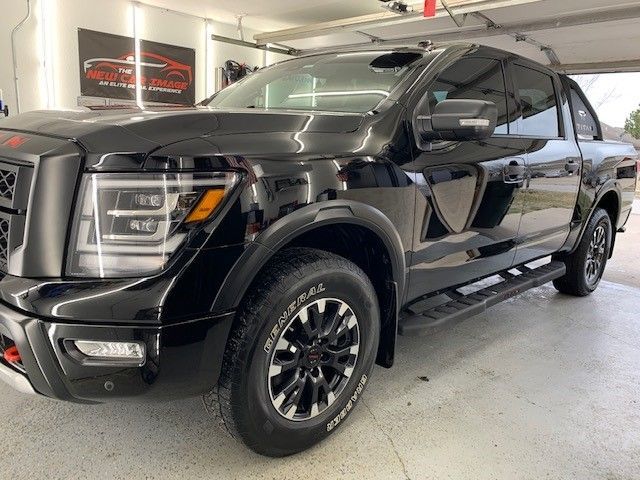A black pickup truck is parked in a garage.