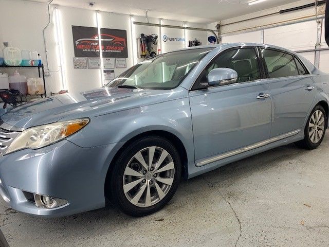 A blue car is parked in a garage.