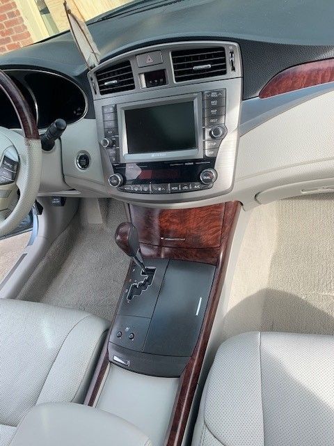 The interior of a car with a steering wheel and dashboard