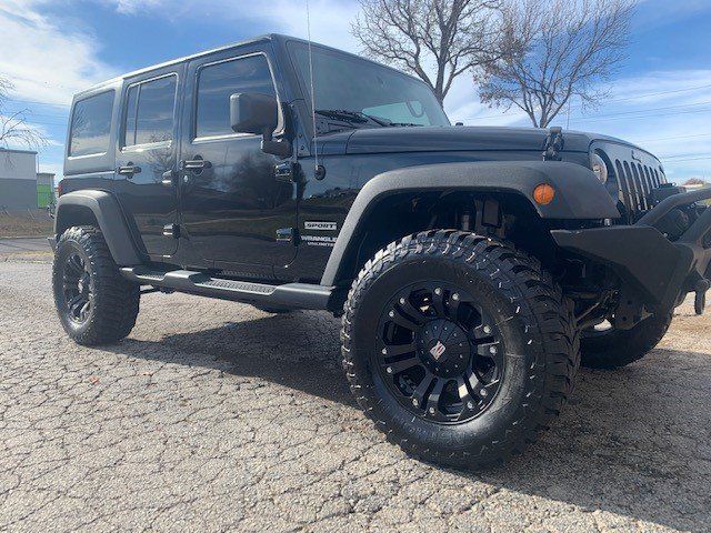 A black jeep is parked on the side of the road.