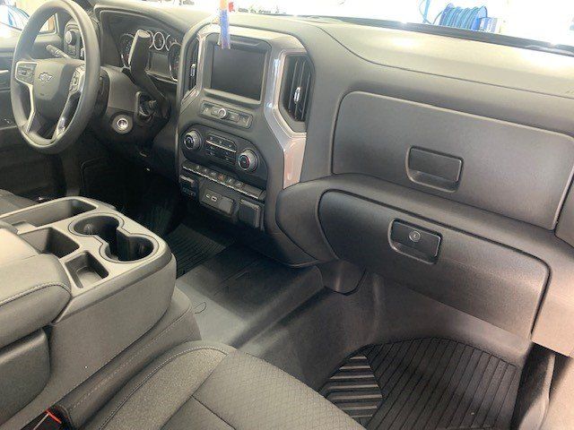 The interior of a truck with a steering wheel and a dashboard.