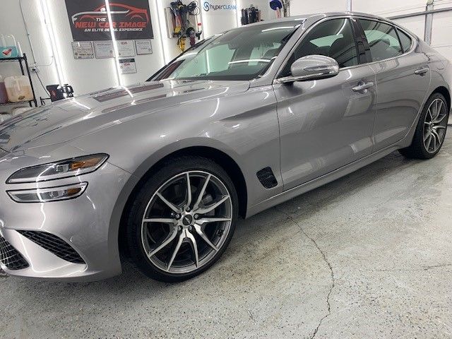 A gray car is parked in a garage.