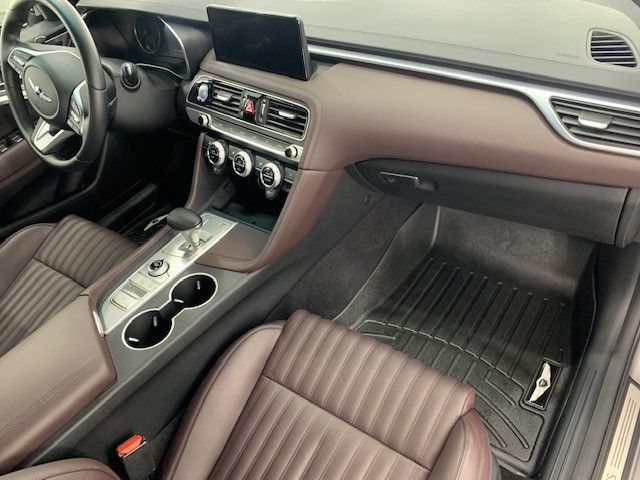 The interior of a car with brown seats and a steering wheel