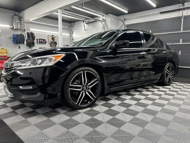A black honda accord is parked in a garage.