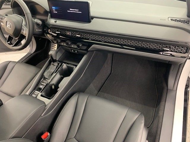 The interior of a car with black leather seats and a steering wheel.