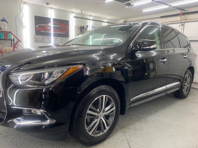 A black car is parked in a garage.