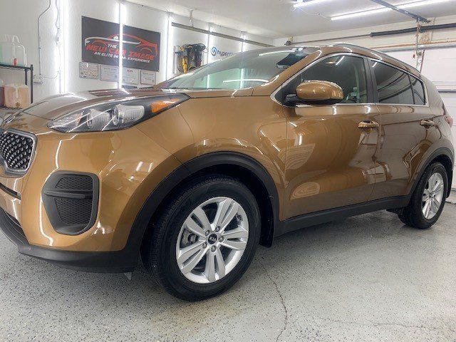 A brown car is parked in a garage.