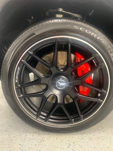 A close up of a car wheel with a scorpion tire on it.