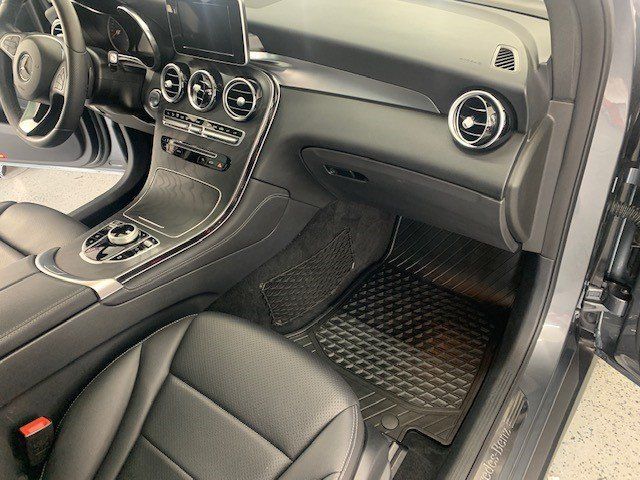 The interior of a car with black leather seats and a dashboard.