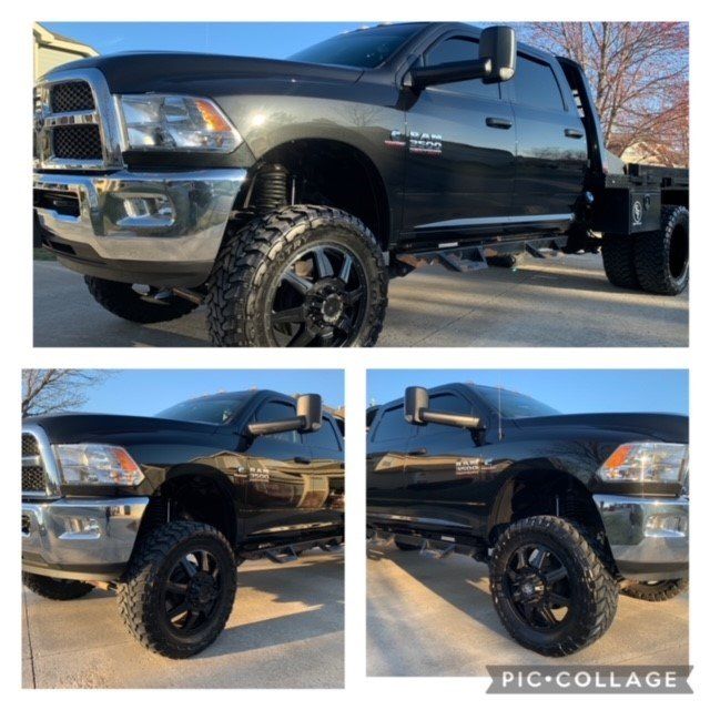 A black dodge ram truck is parked in a parking lot