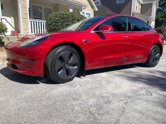 Tesla Model 3 in front of The New Car Image