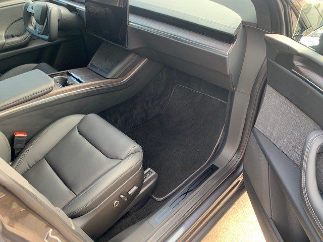 The inside of a tesla model s with the door open