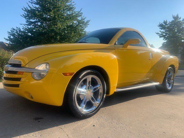A yellow car is parked on the side of the road.