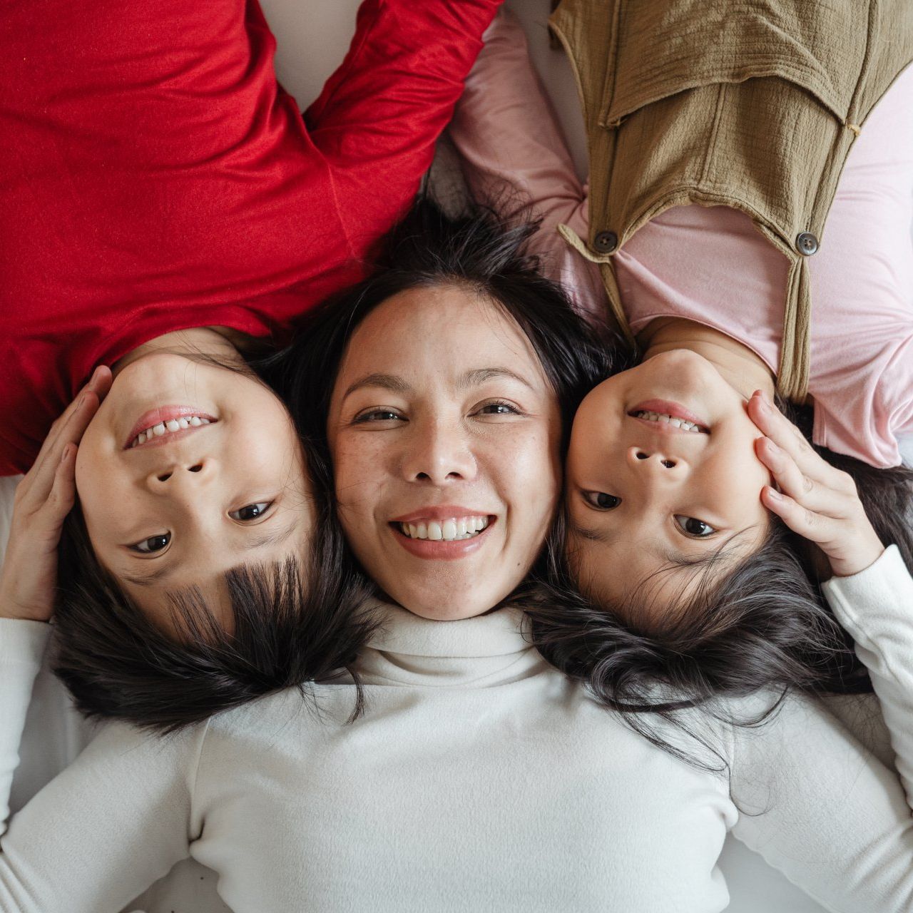 smiling family of a mom and two children