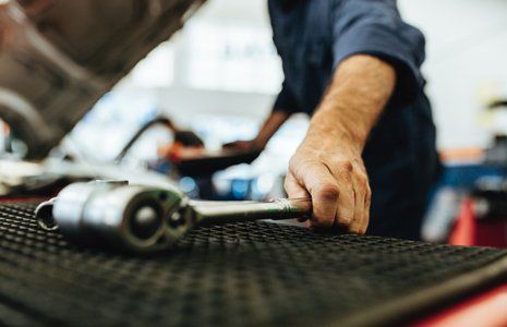 Auto Repair — Mechanic Picking Up A Ratchet Spanner in Agawam, MA