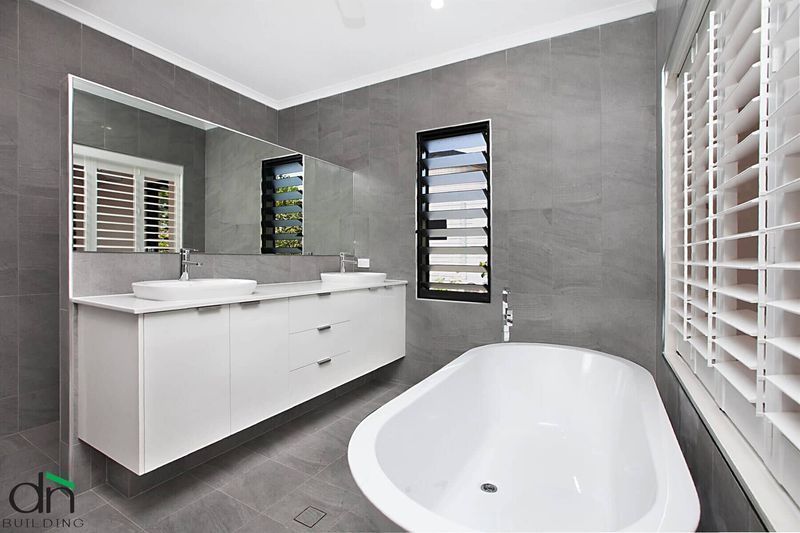 A Bathroom with A Bathtub and Two Sinks — Custom Cabinets Design in Berrimah, NT