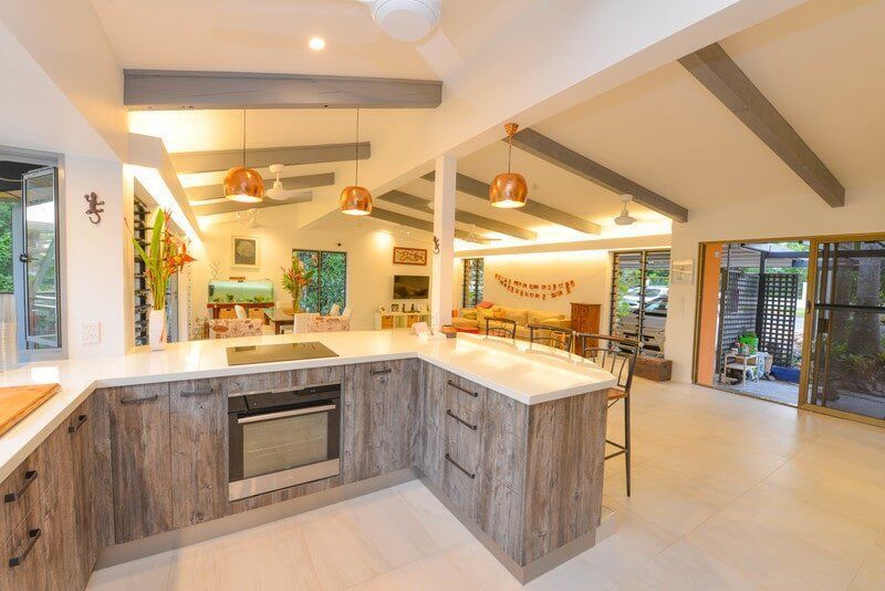 A Kitchen With Warm Lighting and Wooden Cabinetry — Custom Cabinets Design in Virginia, NT