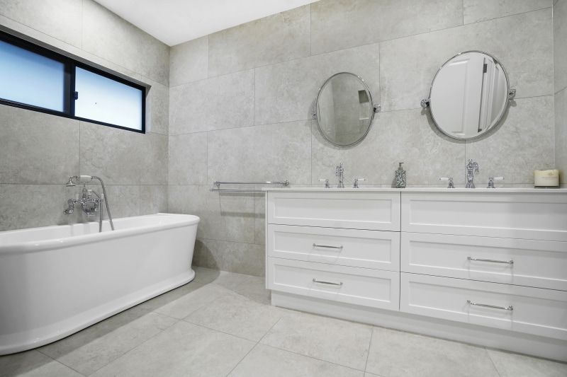 A Bathroom With Two Circle Mirrors Above the Vanities — Custom Cabinets Design in Winnellie, NT