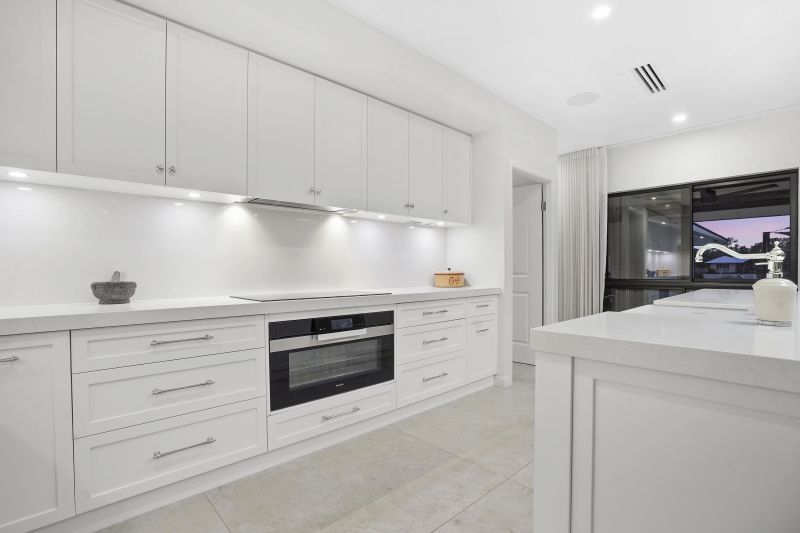 A White Kitchen With a Black Oven — Custom Cabinets Design in Winnellie, NT