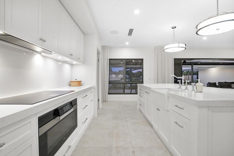 A white kitchen with white cabinets — Custom Cabinets Design in Berrimah, NT