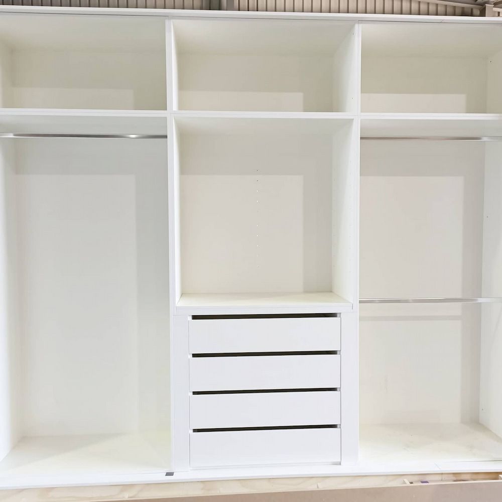 An empty wardrobe with drawers and hanging lines — Custom Cabinets Design in Berrimah, NT