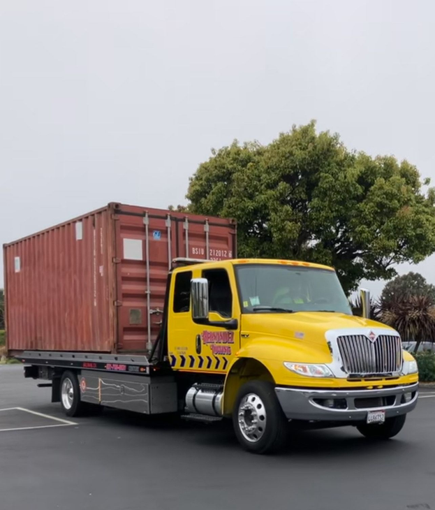 Silver car damaged in accident being towed by a tow truck on asphalt road. Silver car damaged in accident being towed by a tow truck on asphalt road.