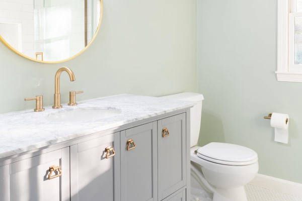 A Bathroom with Sink, Toilet, and Mirror