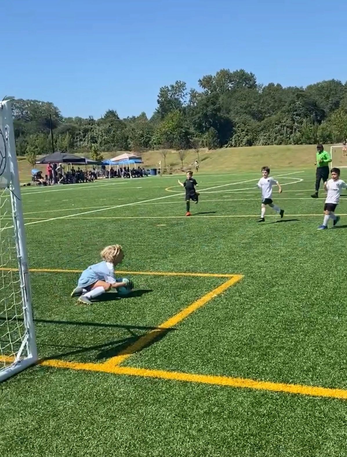 A youth goalkeeper making a save