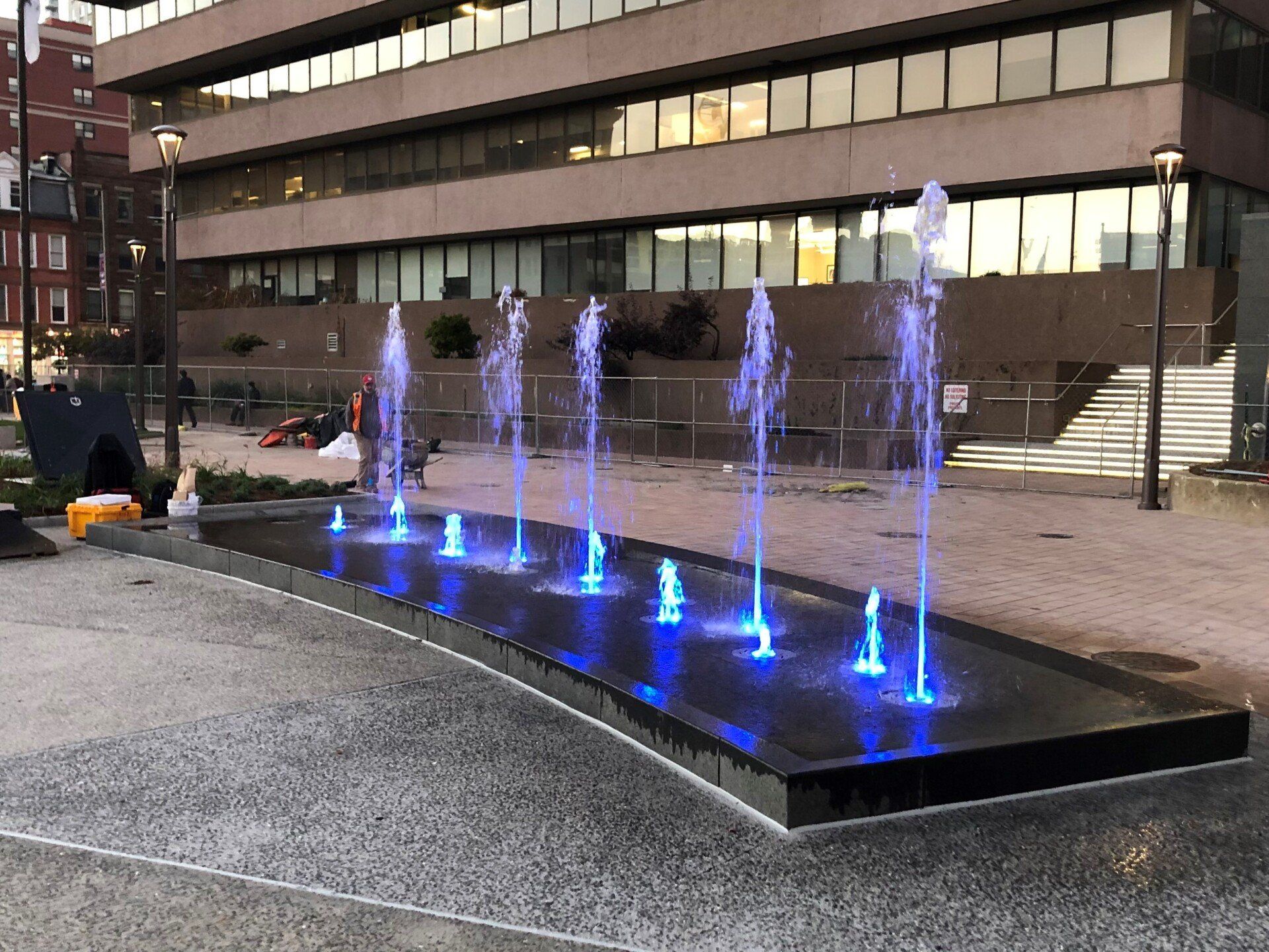 A fountain with blue lights in front of a building