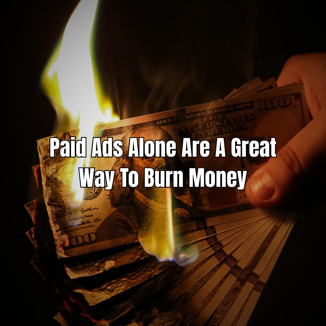 Hand burning a stack of hundred-dollar bills; text reads 