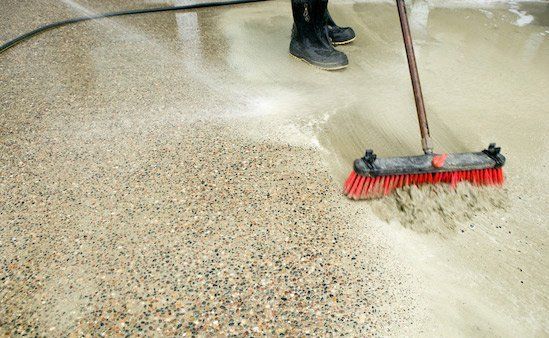 Man Sweeping Floor — Horseshoe, NC — Carolina Concrete Designs, Inc
