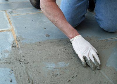 Man Putting Concrete Sealer On Concrete Stamping — Horseshoe, NC — Carolina Concrete Designs, Inc