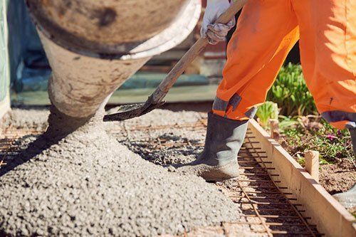Worker Pouring Cement — Horseshoe, NC — Carolina Concrete Designs, Inc