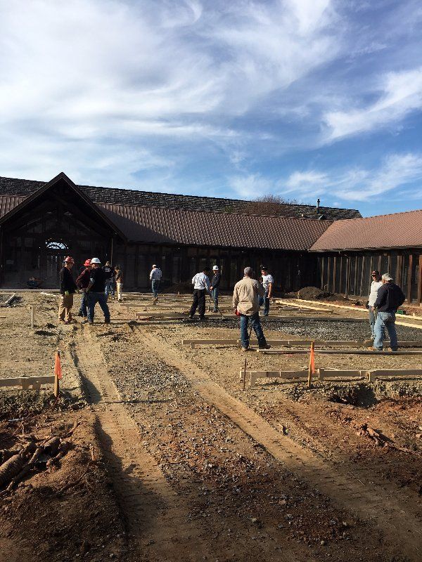 Men Putting Gravel On-Site  — Horseshoe, NC — Carolina Concrete Designs Inc