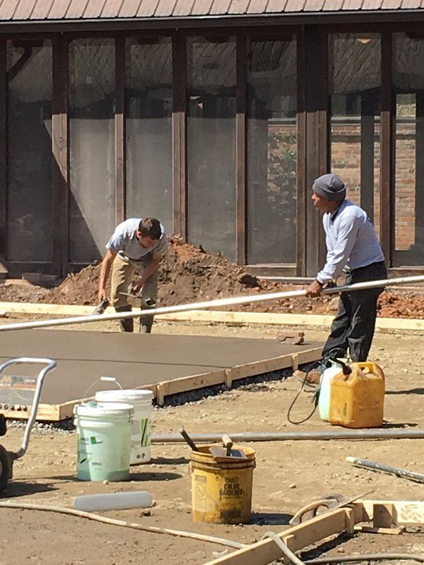 Two Men Leveling Concrete — Horseshoe, NC — Carolina Concrete Designs Inc