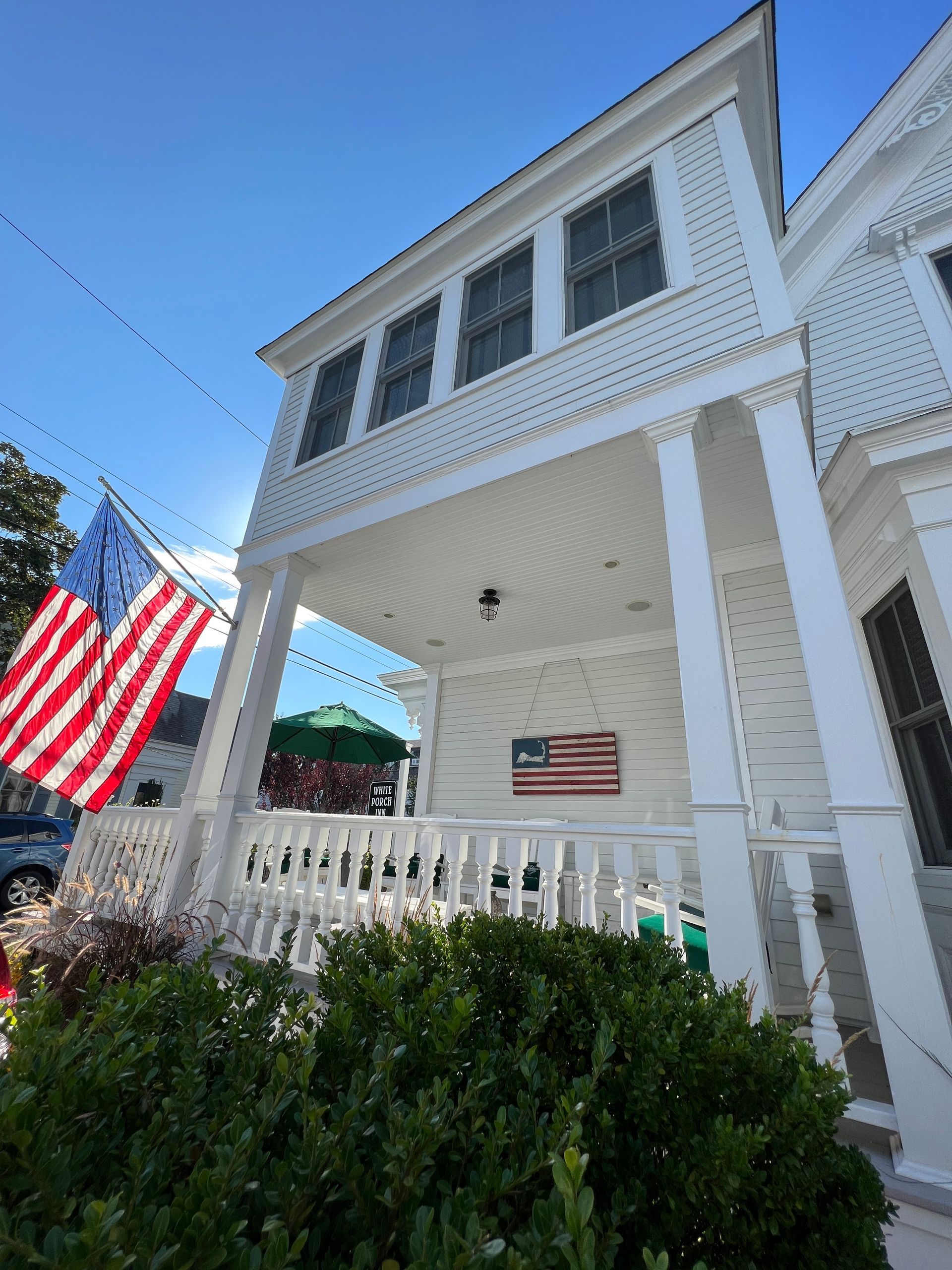 white porch with American Flag.