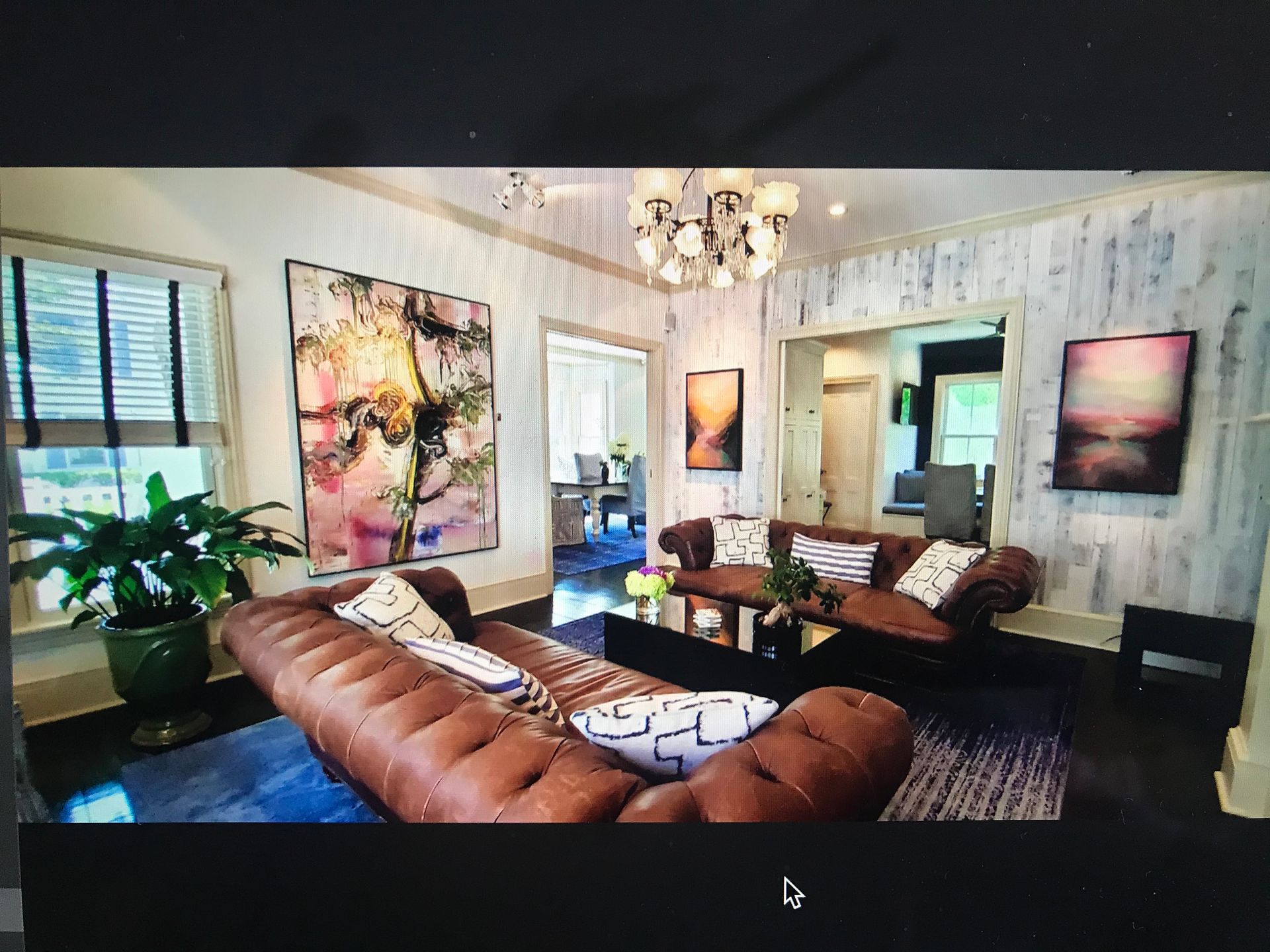 Exterior picture of the porch with rockers at the White Porch Inn Art Hotel