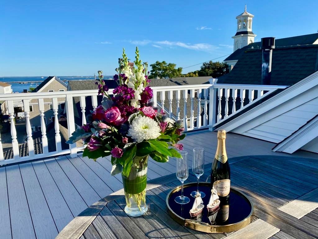 Exterior picture on the roof deck with flowers and champagne over looking the bay.