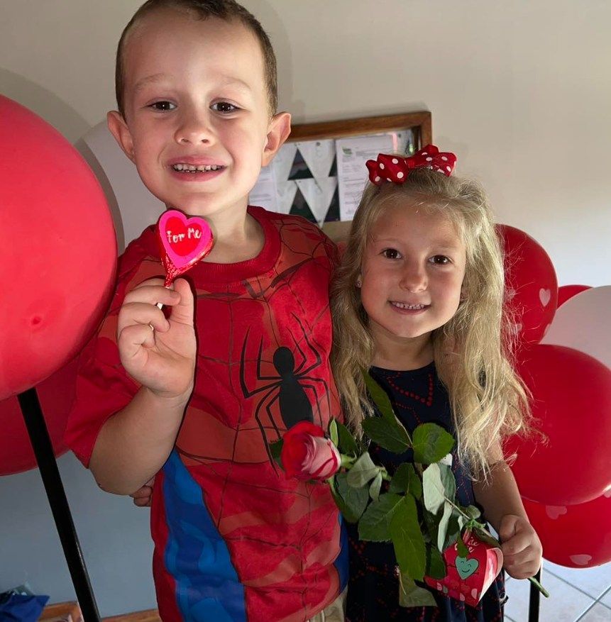 Boy in Spider-Man shirt holds 