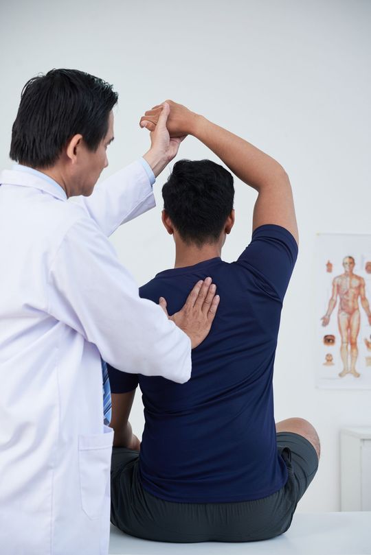 Checking Patient's Spine — Little Falls, NJ — Health on Main